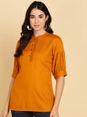 Woman wearing a orange tunic top for women by Nishtha Chadda
