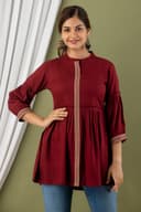 Woman wearing a maroon short kurti tunic top by Nishtha Chadda