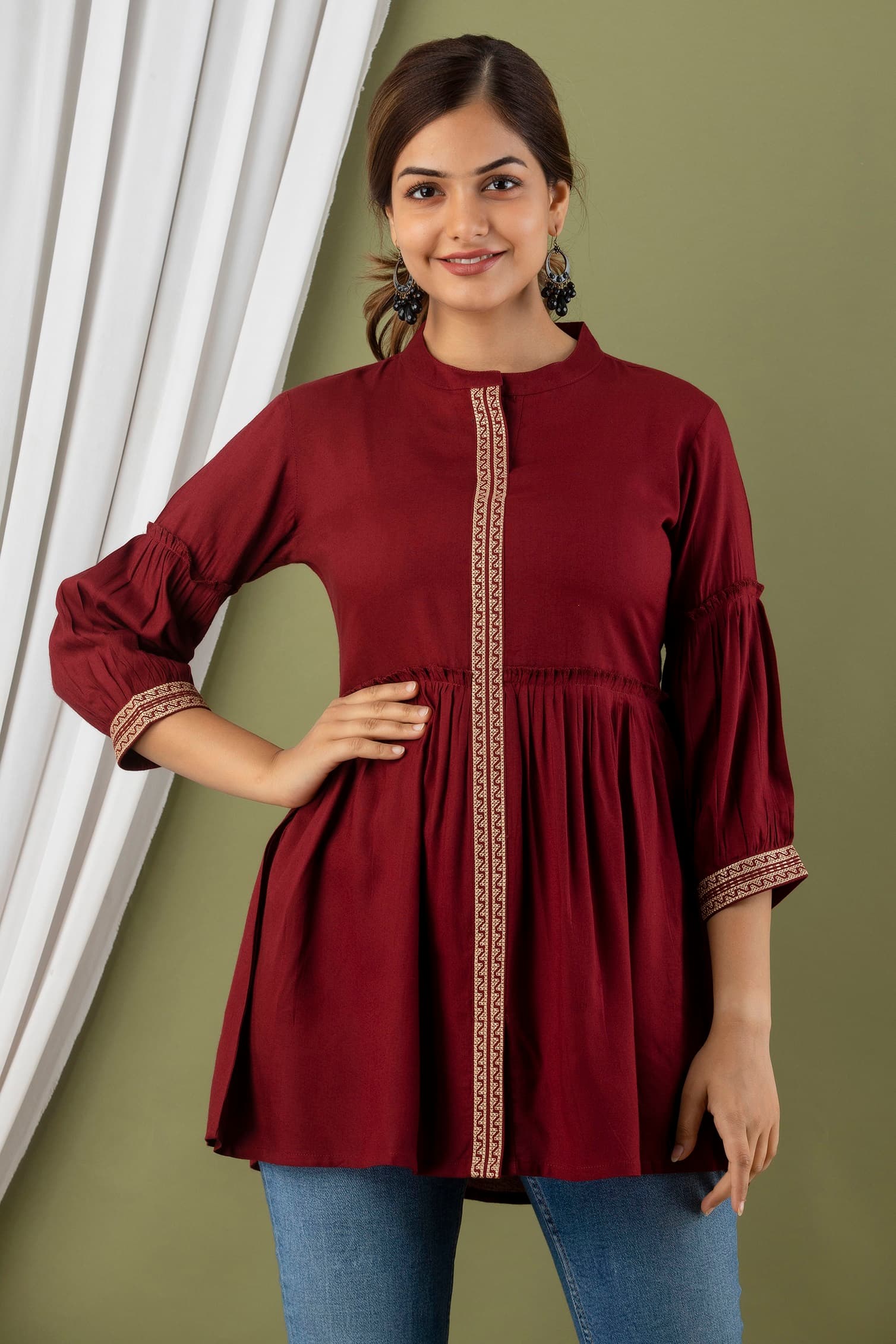 Woman wearing a maroon short kurti tunic top by Nishtha Chadda