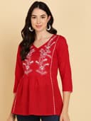Woman wearing a red short kurti tunic top by Nishtha Chadda