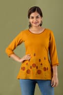 Woman wearing a orange tunic top for women by Nishtha Chadda