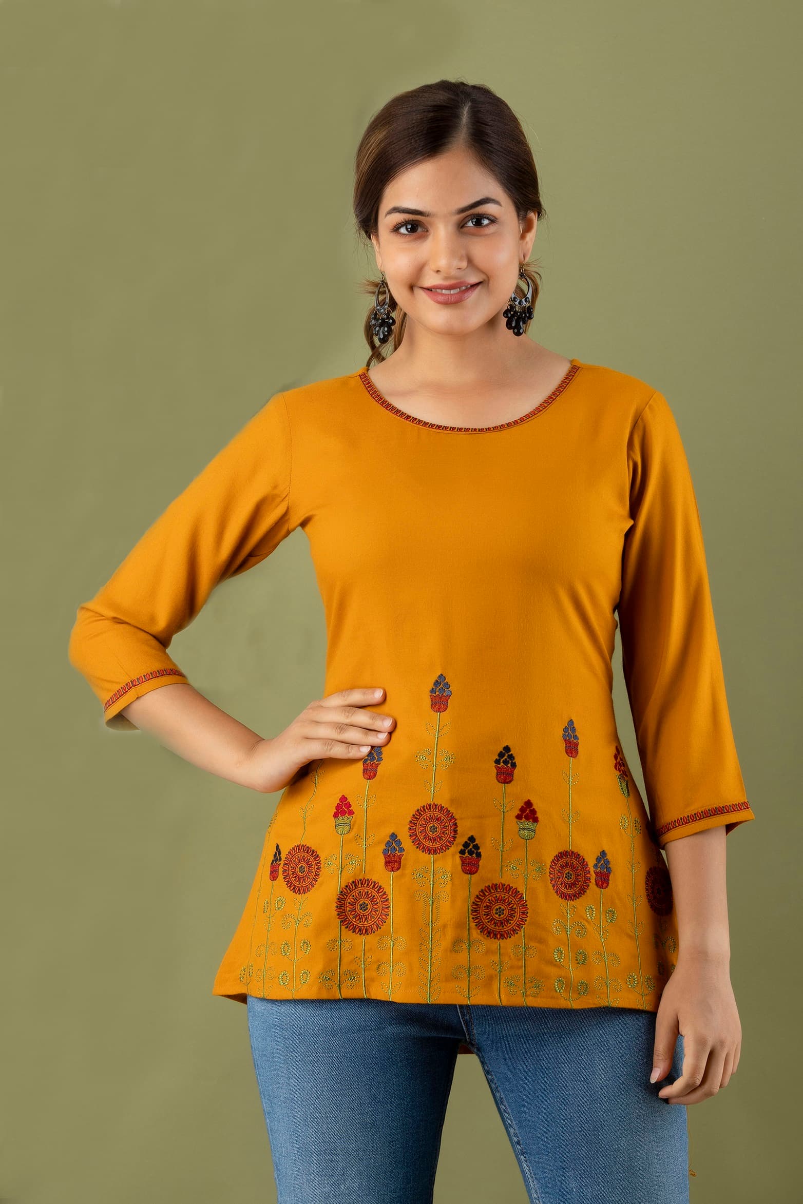 Woman wearing a orange tunic top for women by Nishtha Chadda