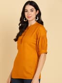 Woman wearing a brown tunic top for women by Nishtha Chadda