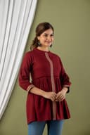 Woman wearing a orange tunic top for women by Nishtha Chadda