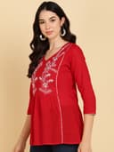 Woman wearing a maroon short kurti tunic top by Nishtha Chadda