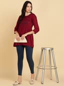Woman wearing a maroon short kurti tunic top by Nishtha Chadda