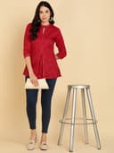 Woman wearing a orange tunic top for women by Nishtha Chadda