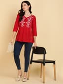 Woman wearing a red short kurti tunic top by Nishtha Chadda
