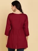 Woman wearing a maroon short kurti tunic top by Nishtha Chadda