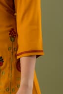 Woman wearing a orange tunic top for women by Nishtha Chadda