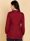 Woman wearing a maroon short kurti tunic top by Nishtha Chadda