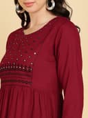 Woman wearing a maroon party wear ethnic kurta style by Nishtha Chadda