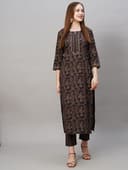 Woman wearing a brown party wear ethnic kurta style by Nishtha Chadda