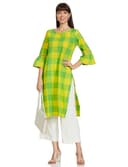 Woman wearing a mustard party wear ethnic kurta style by Nishtha Chadda