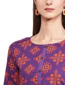 Woman wearing a red party wear ethnic kurta style by Nishtha Chadda