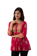 Woman wearing a red party wear ethnic kurta style by Nishtha Chadda