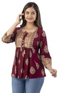 Woman wearing a maroon party wear ethnic kurta style by Nishtha Chadda