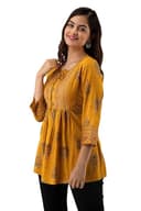 Woman wearing a orange party wear ethnic kurta style by Nishtha Chadda