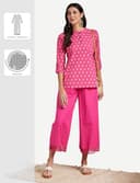 Woman wearing a pink party wear ethnic kurta style by Nishtha Chadda