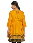 Woman wearing a mustard party wear ethnic kurta style by Nishtha Chadda