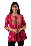 Woman wearing a red party wear ethnic kurta style by Nishtha Chadda