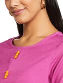 Woman wearing a pink party wear ethnic kurta style by Nishtha Chadda