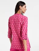 Woman wearing a red party wear ethnic kurta style by Nishtha Chadda