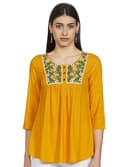 Woman wearing a mustard party wear ethnic kurta style by Nishtha Chadda