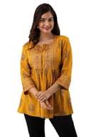 Woman wearing a orange party wear ethnic kurta style by Nishtha Chadda