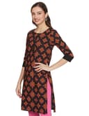 Woman wearing a brown party wear ethnic kurta style by Nishtha Chadda