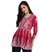 Woman wearing a red party wear ethnic kurta style by Nishtha Chadda
