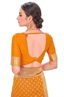 Woman wearing a orange party wear ethnic kurta style by Nishtha Chadda