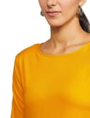 Woman wearing a mustard party wear ethnic kurta style by Nishtha Chadda
