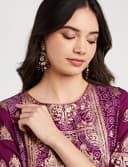 Woman wearing a maroon party wear ethnic kurta style by Nishtha Chadda