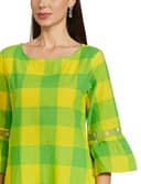 Woman wearing a mustard party wear ethnic kurta style by Nishtha Chadda