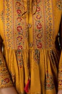Woman wearing a orange party wear ethnic kurta style by Nishtha Chadda