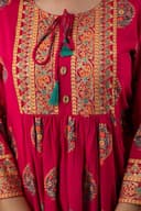 Woman wearing a red party wear ethnic kurta style by Nishtha Chadda