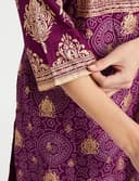 Woman wearing a maroon party wear ethnic kurta style by Nishtha Chadda