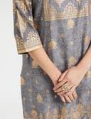 Woman wearing a grey party wear ethnic kurta style by Nishtha Chadda
