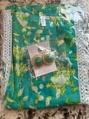 Woman wearing a teal embroidered kurti set by Nishtha Chadda