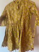 Woman wearing a brown embroidered kurti set by Nishtha Chadda