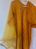Woman wearing a brown embroidered kurti set by Nishtha Chadda