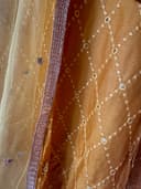 Woman wearing a brown embroidered kurti set by Nishtha Chadda