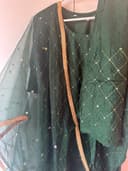 Woman wearing a brown embroidered kurti set by Nishtha Chadda