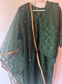 Woman wearing a brown embroidered kurti set by Nishtha Chadda