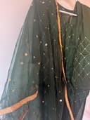 Woman wearing a brown embroidered kurti set by Nishtha Chadda