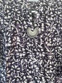 Woman wearing a purple embroidered kurti set by Nishtha Chadda