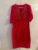Woman wearing a red embroidered kurti set by Nishtha Chadda