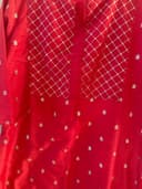 Woman wearing a red embroidered kurti set by Nishtha Chadda
