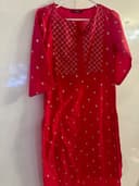 Woman wearing a red embroidered kurti set by Nishtha Chadda